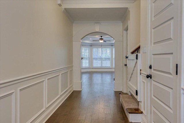 818 Fenwick Ct, Grovetown, GA 30813 - hallway with crown molding, arched walkways, a decorative wall, dark wood finished floors, and a wainscoted wall