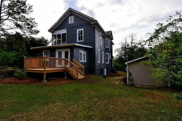 back of house with a yard and a wooden deck