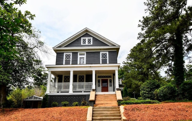 american foursquare style home featuring stairs and covered porch