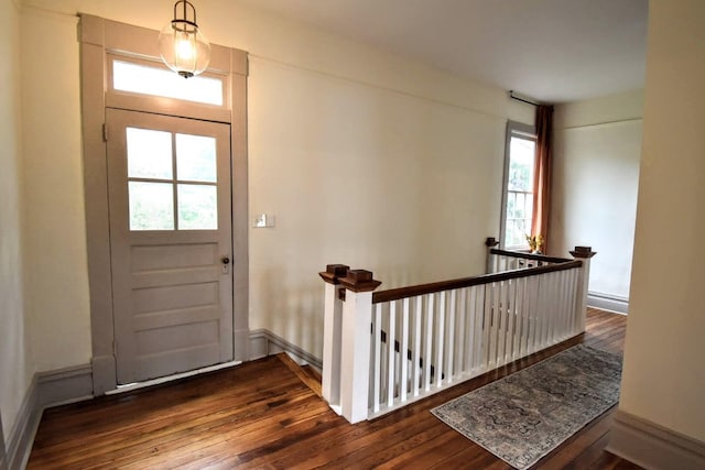 entrance foyer featuring baseboards and dark wood-type flooring