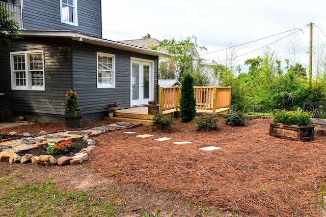 view of yard featuring french doors and a deck