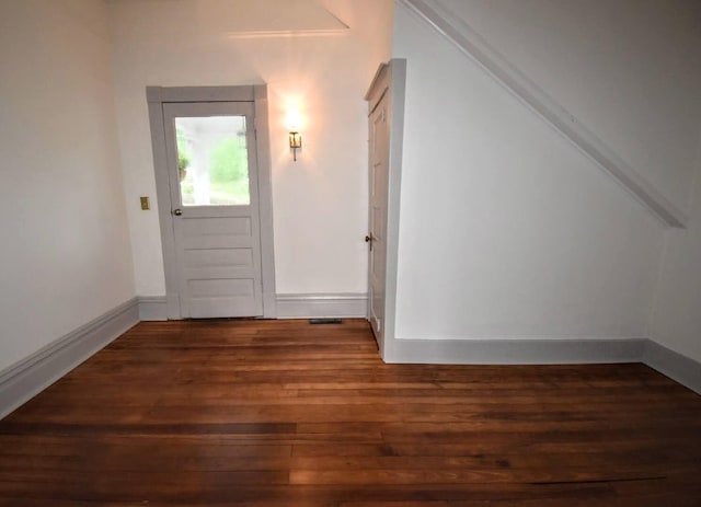 foyer entrance with wood finished floors and baseboards