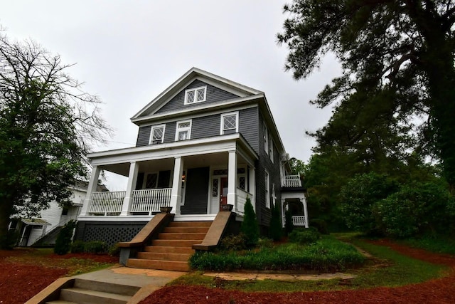 view of front of home with stairway and covered porch