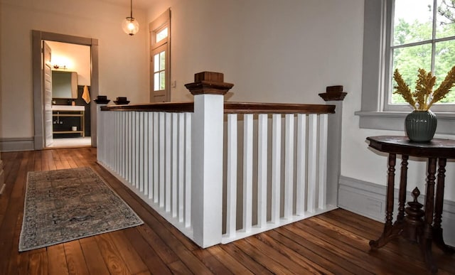 hallway with hardwood / wood-style floors