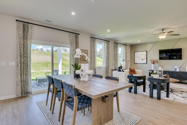 dining area featuring ceiling fan and light wood-type flooring