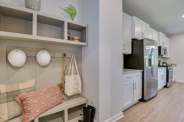 mudroom with light hardwood / wood-style flooring