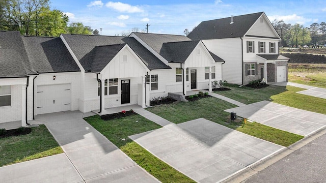 view of front of property with a front yard and a garage