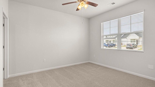 unfurnished room with ceiling fan and light carpet