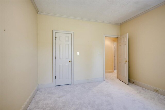 4482 Persimmon St, Evans, GA 30809 - unfurnished bedroom with ornamental molding, carpet, a textured ceiling, and baseboards