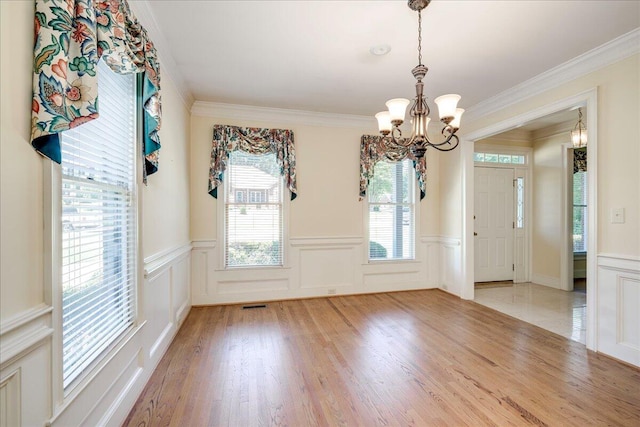 4482 Persimmon St, Evans, GA 30809 - unfurnished dining area featuring a decorative wall, a chandelier, a wainscoted wall, ornamental molding, and light wood finished floors