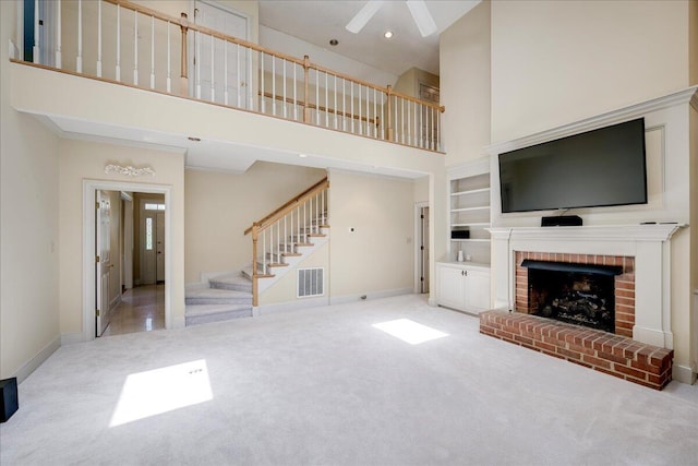 4482 Persimmon St, Evans, GA 30809 - unfurnished living room with carpet floors, a high ceiling, stairs, a fireplace, and baseboards