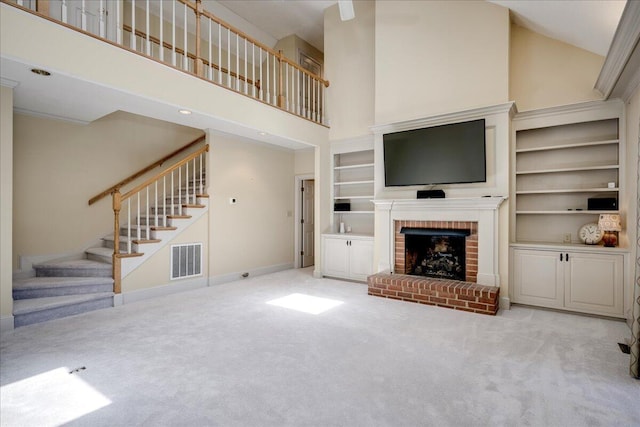 4482 Persimmon St, Evans, GA 30809 - unfurnished living room featuring a high ceiling, carpet floors, stairway, a fireplace, and baseboards