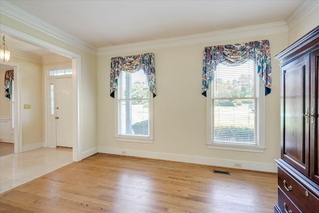 4482 Persimmon St, Evans, GA 30809 - foyer entrance featuring plenty of natural light, crown molding, baseboards, and light wood-type flooring