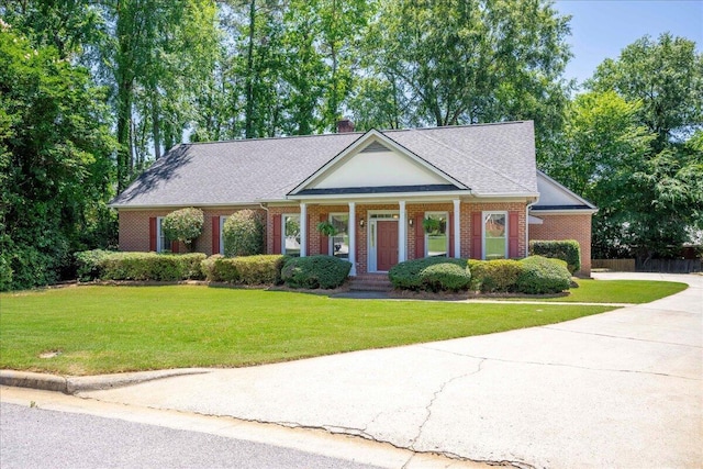 4482 Persimmon St, Evans, GA 30809 - greek revival inspired property featuring a front lawn, covered porch, a chimney, concrete driveway, and brick siding