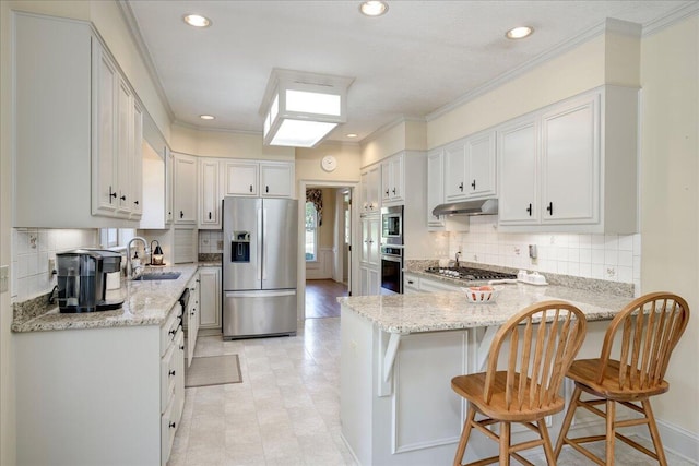 4482 Persimmon St, Evans, GA 30809 - kitchen featuring stainless steel appliances, under cabinet range hood, a sink, a peninsula, and light stone countertops