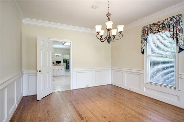 4482 Persimmon St, Evans, GA 30809 - unfurnished room with a chandelier, ornamental molding, light wood-style floors, a decorative wall, and a wainscoted wall