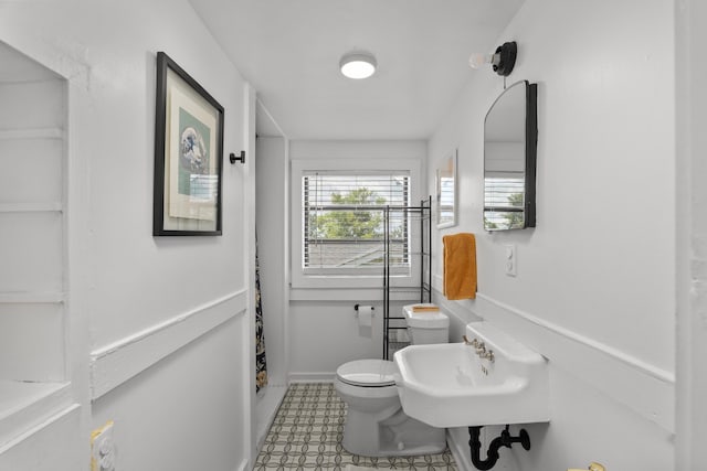 1512 Johns Rd, Augusta, GA 30904 - bathroom with toilet, a sink, and baseboards