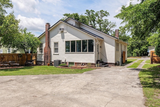 1512 Johns Rd, Augusta, GA 30904 - view of front of property with a chimney, cooling unit, stucco siding, concrete driveway, and entry steps
