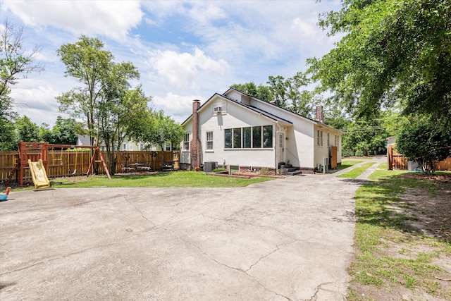1512 Johns Rd, Augusta, GA 30904 - view of front of home featuring a chimney, entry steps, stucco siding, central air condition unit, and a patio area