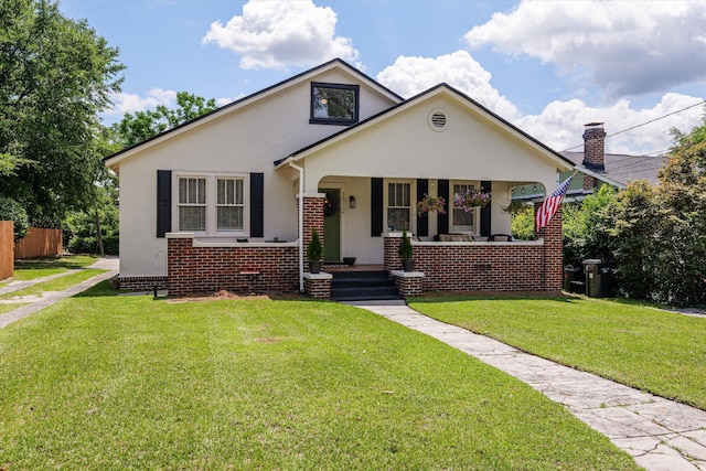 1512 Johns Rd, Augusta, GA 30904 - bungalow-style home with stucco siding, covered porch, brick siding, and a chimney