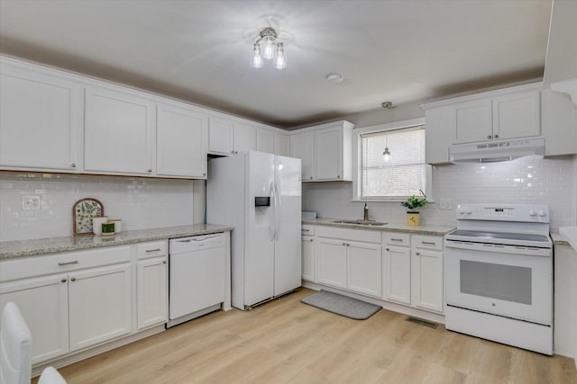 kitchen featuring white appliances, white cabinetry, a sink, and under cabinet range hood