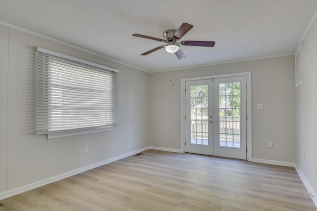 spare room featuring french doors, crown molding, light wood-style flooring, ceiling fan, and baseboards