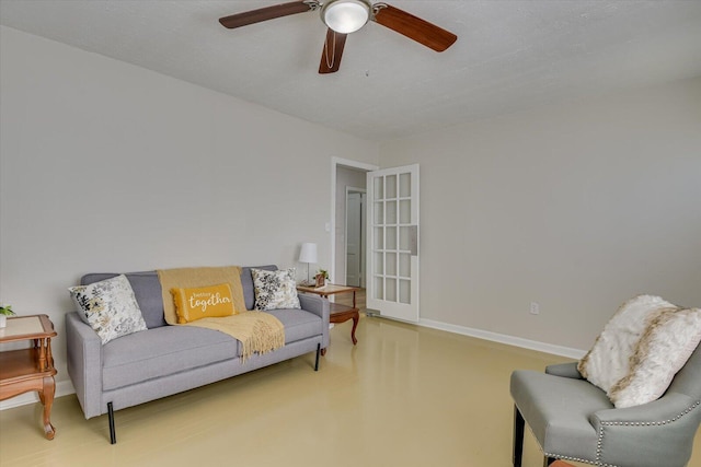 interior space with a ceiling fan and baseboards