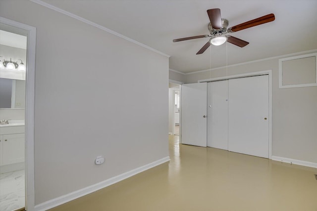 unfurnished bedroom featuring a closet, ornamental molding, ceiling fan, ensuite bath, and baseboards