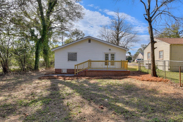 back of property featuring french doors and fence