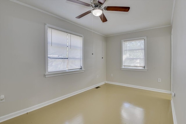 spare room featuring crown molding, a ceiling fan, visible vents, and baseboards