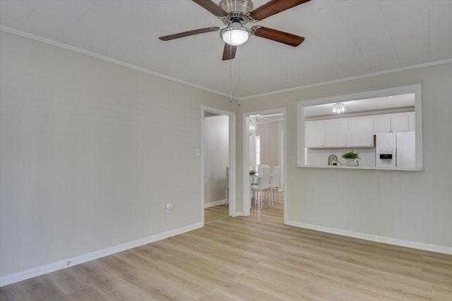 unfurnished living room featuring light wood-style floors, baseboards, and ornamental molding