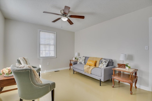 living room featuring baseboards, a textured ceiling, visible vents, and a ceiling fan