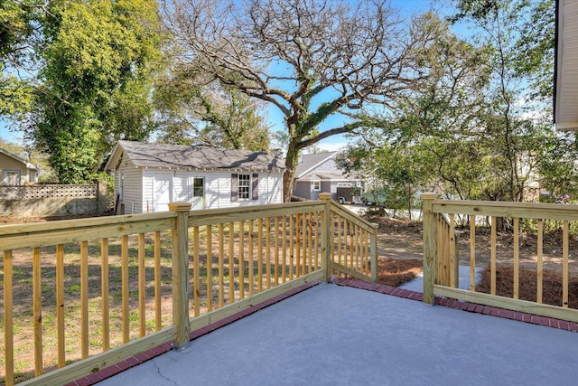 wooden terrace with an outdoor structure and a shed