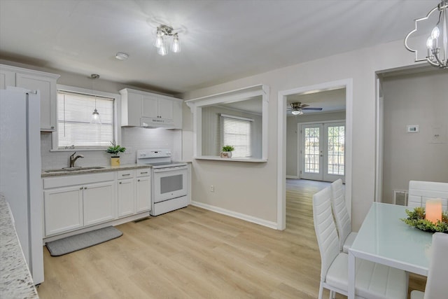 kitchen with white appliances, a sink, white cabinetry, and decorative light fixtures