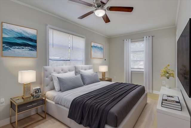 bedroom featuring ornamental molding, baseboards, light wood finished floors, and a ceiling fan