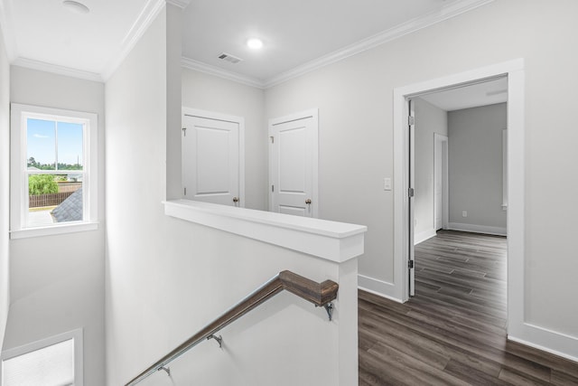 hallway featuring dark wood finished floors, ornamental molding, an upstairs landing, baseboards, and visible vents