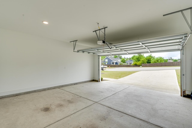 garage with baseboards and a garage door opener