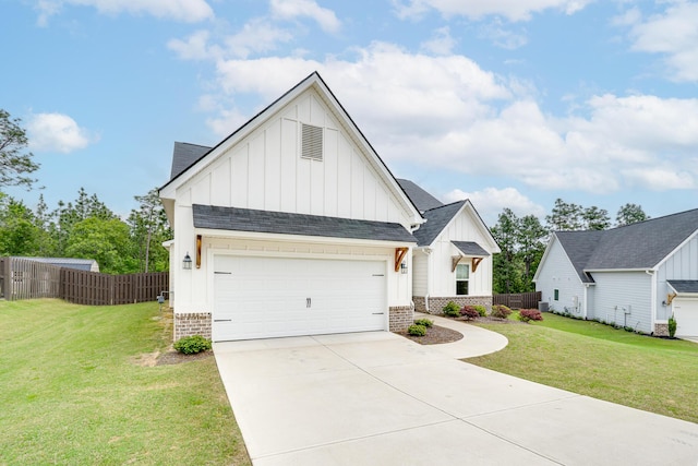modern farmhouse featuring fence, board and batten siding, a front yard, and driveway