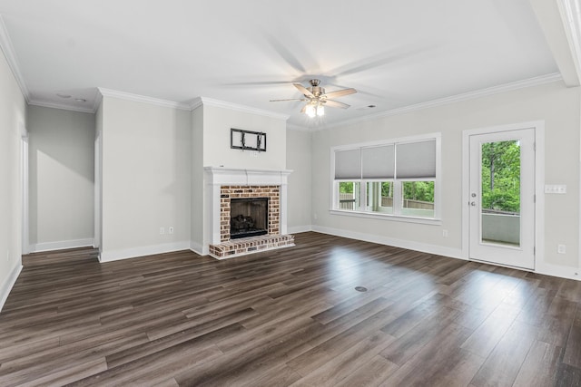 unfurnished living room featuring baseboards, ornamental molding, dark wood finished floors, a brick fireplace, and a ceiling fan