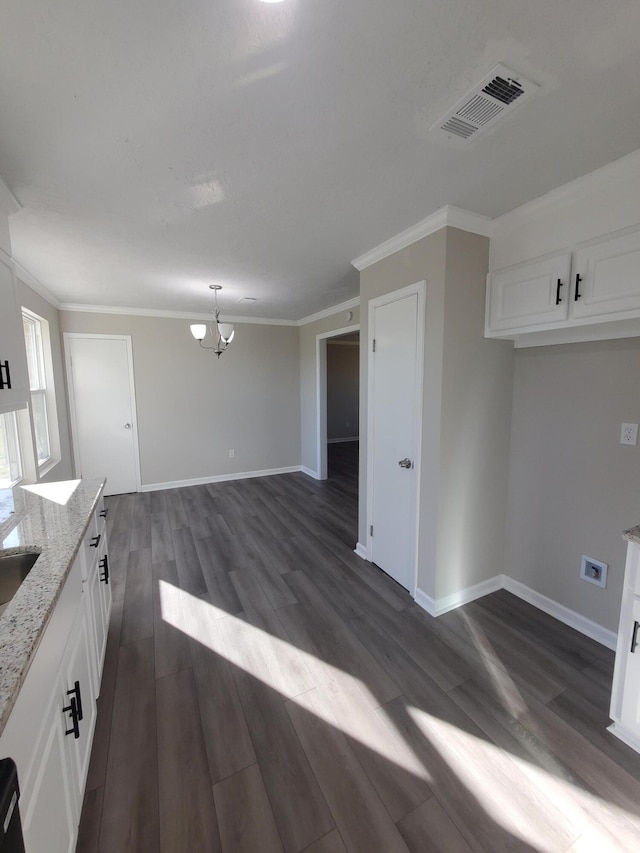 kitchen featuring light stone countertops, dark hardwood / wood-style flooring, a chandelier, white cabinetry, and hanging light fixtures