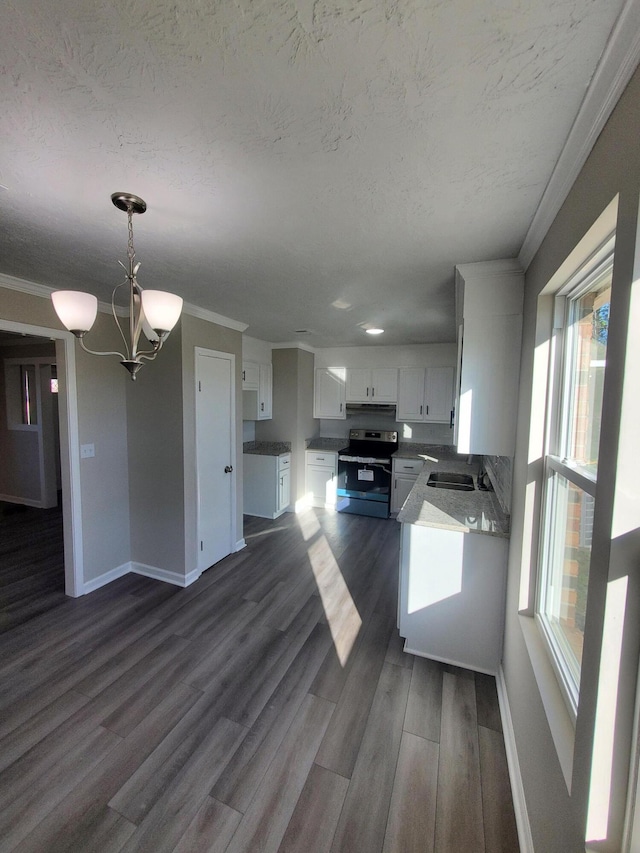 kitchen with stainless steel electric range, hanging light fixtures, a notable chandelier, a healthy amount of sunlight, and white cabinetry