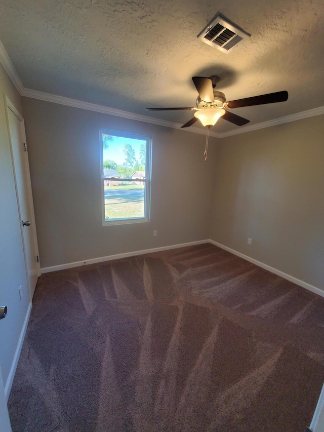 carpeted empty room featuring ceiling fan, a textured ceiling, and ornamental molding