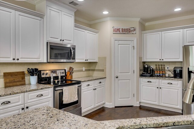 4074 Ellington Dr, Grovetown, GA 30813 - kitchen with appliances with stainless steel finishes, dark wood-style flooring, white cabinetry, crown molding, and tasteful backsplash