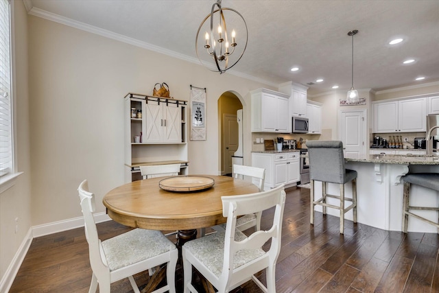 4074 Ellington Dr, Grovetown, GA 30813 - dining room with arched walkways, crown molding, dark wood-style floors, recessed lighting, and baseboards