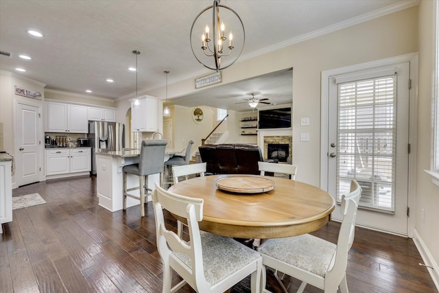 4074 Ellington Dr, Grovetown, GA 30813 - dining room with ornamental molding, a stone fireplace, dark wood finished floors, recessed lighting, and a ceiling fan