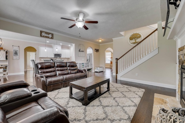 4074 Ellington Dr, Grovetown, GA 30813 - living room featuring arched walkways, ceiling fan, dark wood-type flooring, stairway, and ornamental molding