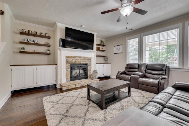 4074 Ellington Dr, Grovetown, GA 30813 - living room with dark wood-type flooring, a ceiling fan, ornamental molding, a stone fireplace, and a textured ceiling