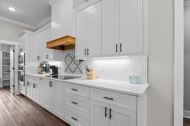 7181 Moontown Rd, Appling, GA 30802 - kitchen with appliances with stainless steel finishes, crown molding, dark wood-style flooring, white cabinets, and light countertops