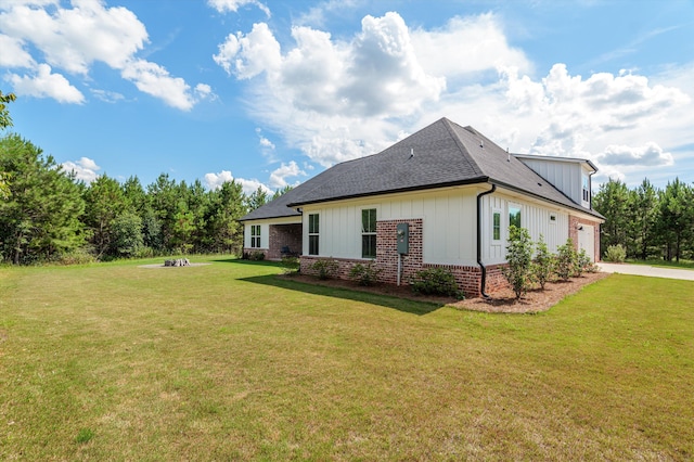 7181 Moontown Rd, Appling, GA 30802 - view of side of property featuring driveway, an attached garage, a shingled roof, a lawn, and brick siding