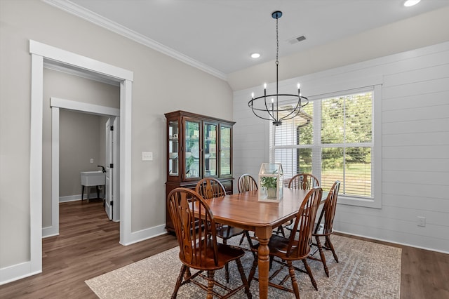 7181 Moontown Rd, Appling, GA 30802 - dining space featuring a chandelier, crown molding, dark wood finished floors, recessed lighting, and wooden walls
